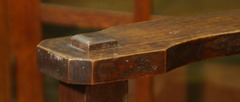 Detail clip-corner arm with bold through-tenon.